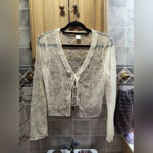 Sheer floral patterned lacey cream colored tie front cardigan